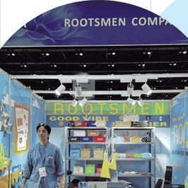 The ROOTSMEN stand under its company banner
