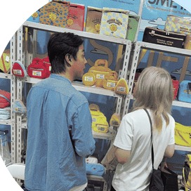 Buyers reviewing cosmetic bags and travel organizers on the shelves